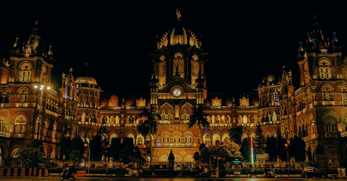 Night view of the iconic Chhatrapati Shivaji Terminus in Mumbai, beautifully lit and historic.