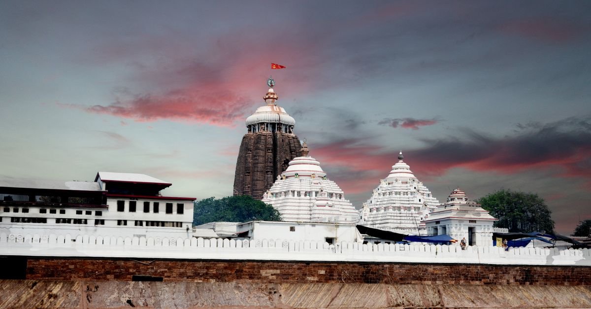 Scenic view of the historic Jagannath Temple in Puri, Odisha during sunset with vibrant skies.