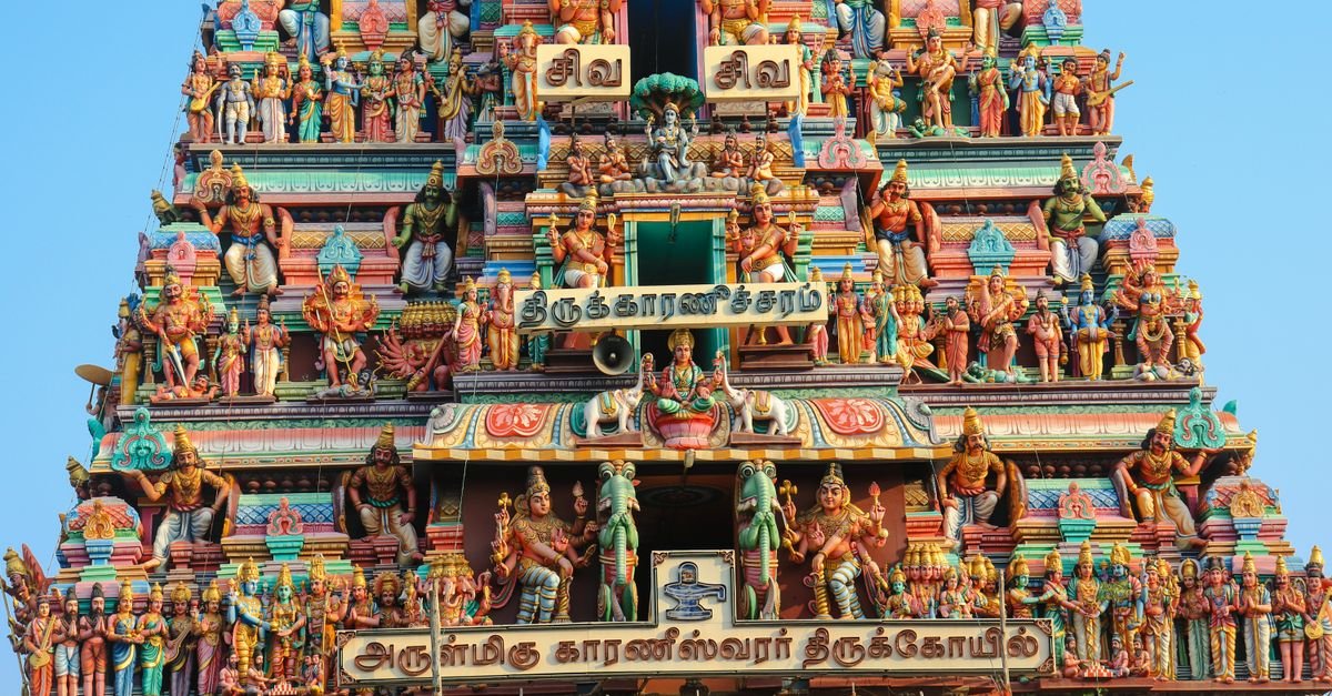 Intricately ornamented facade of a Hindu temple in Chennai, showcasing colorful statues and religious motifs.